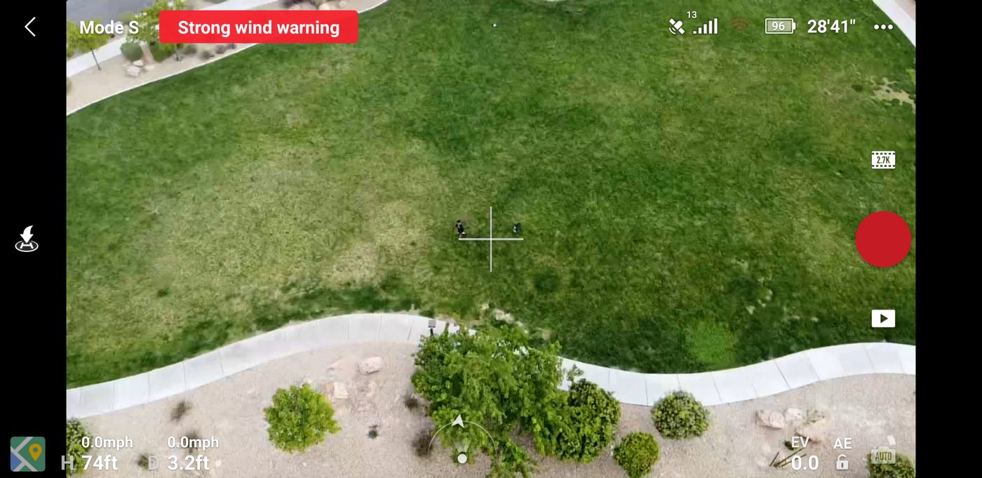 DJI Fly app over a park showing a red Strong wind warning flag